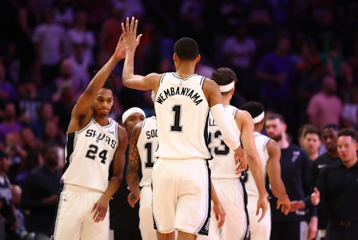Nov 2, 2023; Phoenix, Arizona, USA; San Antonio Spurs center Victor Wembanyama (1) celebrates a dunk with teammates against the Phoenix Suns in the first half at Footprint Center.